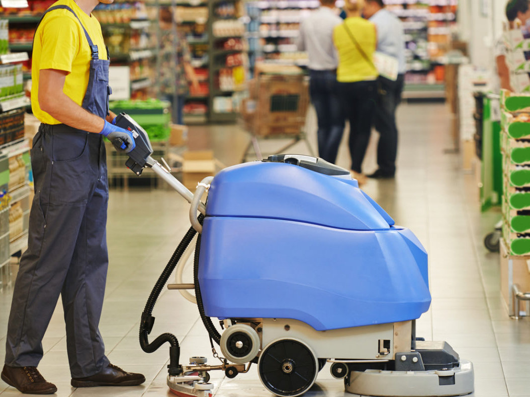Industrial cleaning Adelaide: ride-on floor scrubber cleaning a large commercial floor
