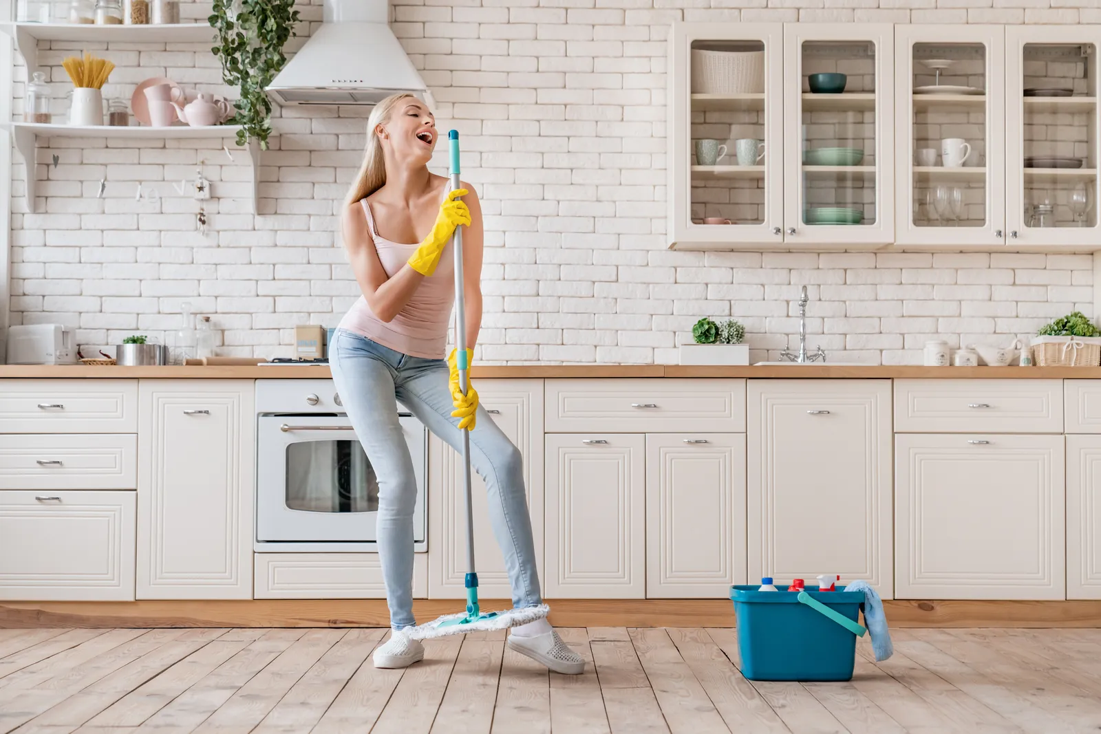 Domestic cleaning Adelaide: cleaner mopping a bright kitchen floor in a home